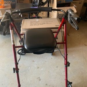 Walker with a seat. It also has breaks on top of the handles.